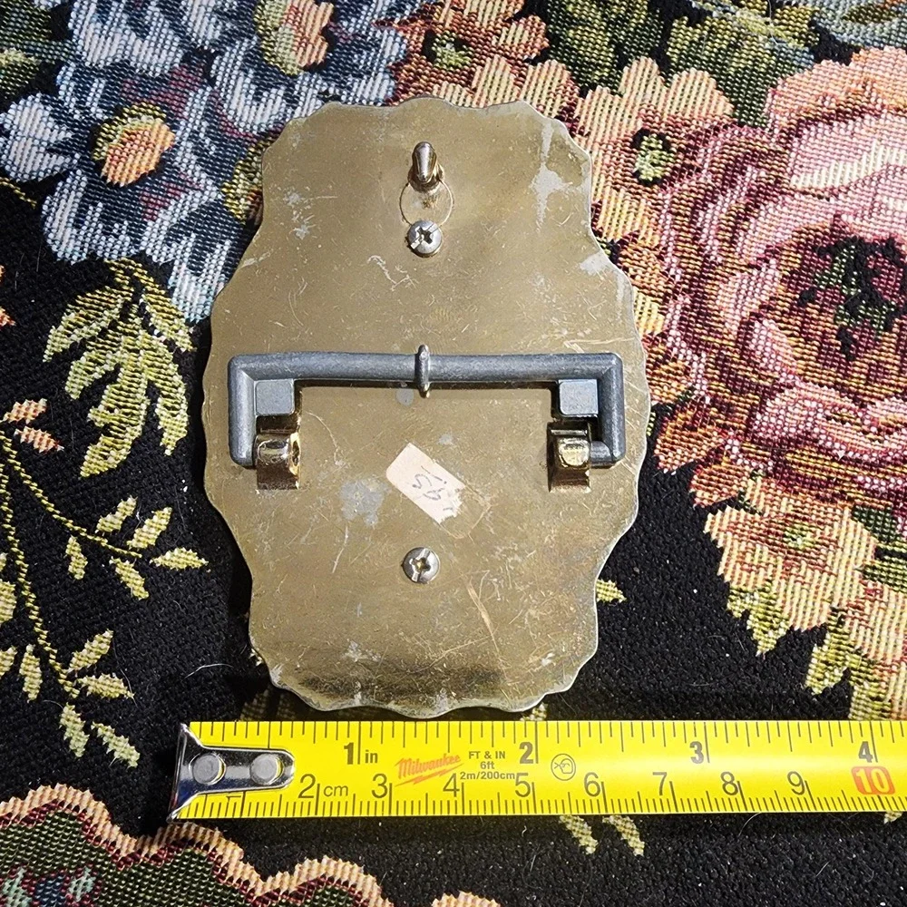 Vintage Metal Belt Buckle, Brass, Round Token Holder, holding a piece of leather